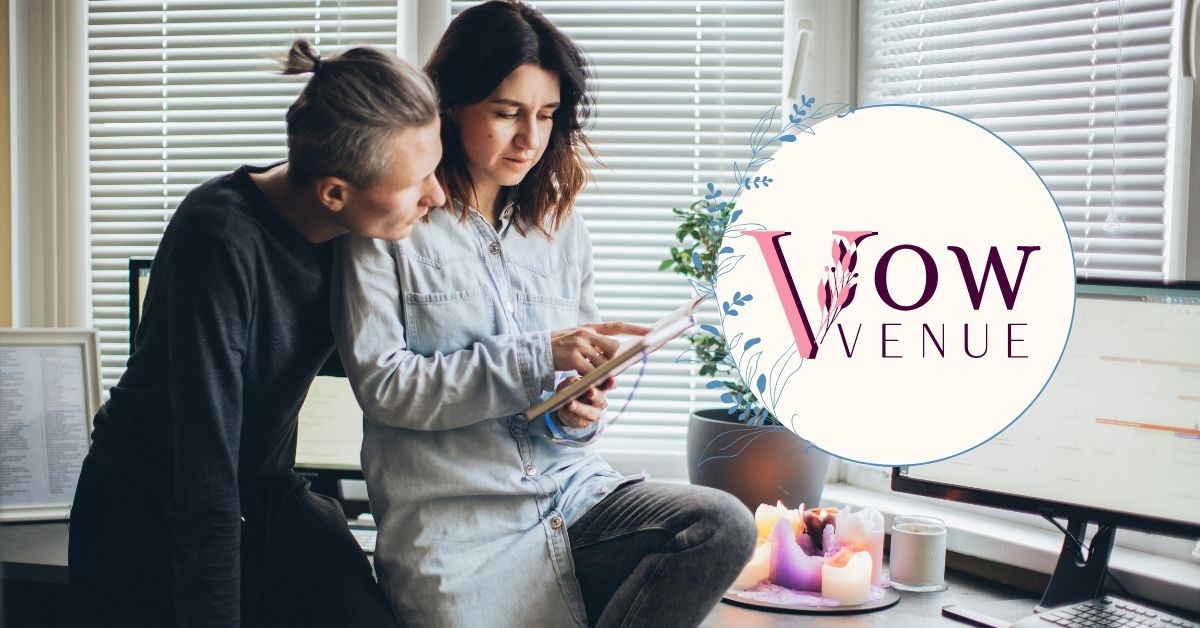 a man and woman looking at a tablet for wedding budget