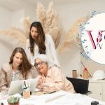 Three ladies collaborating while looking at the same laptop, discussing strategies to book more weddings and grow their wedding venue business.